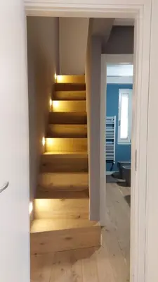 a staircase with wooden steps in a room with lights at AntoX3 in Palermo