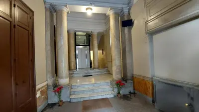 a hallway with pillars and stairs in a building at AntoX3 in Palermo