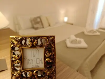 a picture frame sitting on a table in a bedroom at Tiny Home Di Carlo in Palermo