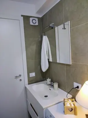a bathroom with a white sink and a mirror at Tiny Home Di Carlo in Palermo