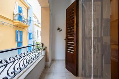 a wooden door in a balcony with a window at Plaza Del Mar Casa vacanza Mondello in Palermo