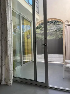 an open sliding glass door with a view of a patio at CasaLavinaro in Castellammare del Golfo