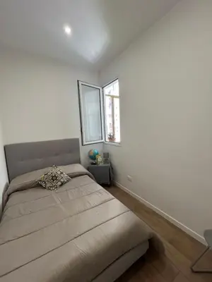 a bed in a bedroom with a large window at Casa Annachiara in Palermo