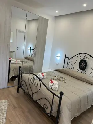 a bedroom with a bed and a large mirror at Casa Annachiara in Palermo