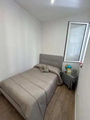 a small bedroom with a bed and a mirror at Casa Annachiara in Palermo