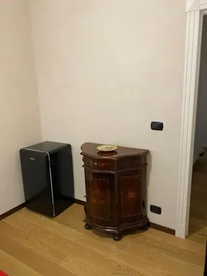 a small wooden table in a room with a speaker at B&B Duca di Maqueda nel pieno centro dell citta' a 5 minuti dalla stazione degli autobus e dei treni in Palermo