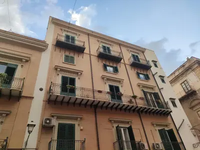 a tall building with balconies on the side of it at B&B Duca di Maqueda nel pieno centro dell citta' a 5 minuti dalla stazione degli autobus e dei treni in Palermo