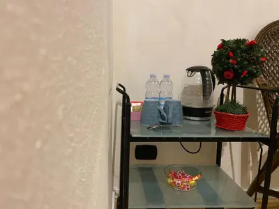 a shelf with bottles of water and a bowl of candy at B&B Duca di Maqueda nel pieno centro dell citta' a 5 minuti dalla stazione degli autobus e dei treni in Palermo
