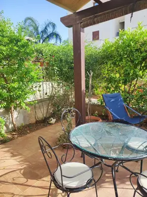a glass table and chairs on a patio at Cale e Calle in Terrasini