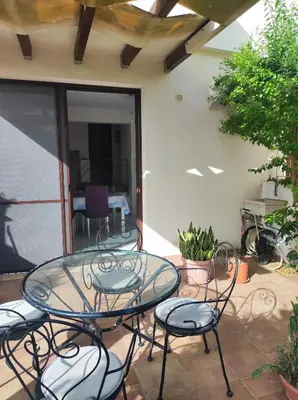 a glass table and chairs on a patio at Cale e Calle in Terrasini