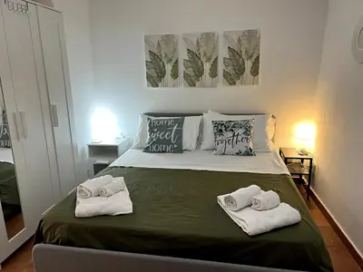 a bedroom with a bed with towels on it at Casa Fico D'India in Cinisi