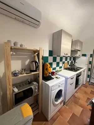 a kitchen with a washing machine and a washer at Casa Fico D'India in Cinisi