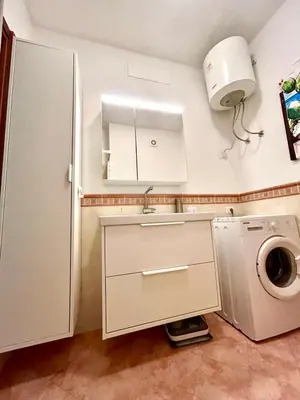 a kitchen with a sink and a washing machine at casa NiKa a 150 mt dal mare in Isola delle Femmine