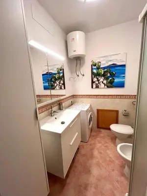 a bathroom with a sink and a toilet at casa NiKa a 150 mt dal mare in Isola delle Femmine