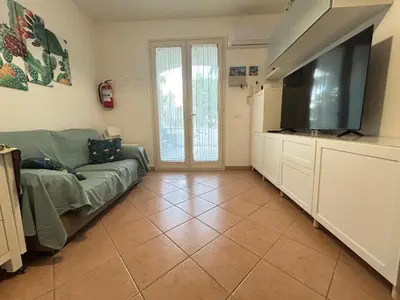 a living room with a couch and a flat screen tv at casa NiKa a 150 mt dal mare in Isola delle Femmine
