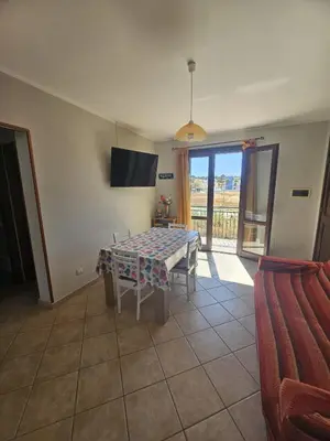 a living room with a table and a tv at David's Apartment in San Vito lo Capo