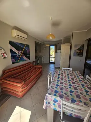 a living room with a table and a couch at David's Apartment in San Vito lo Capo