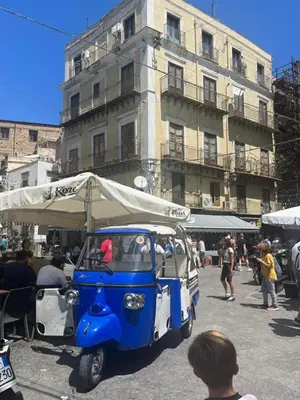 a small blue and white food cart parked in front of a building at Appartamento Casa Florio Mondello in Palermo