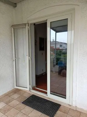 a sliding glass door on a house with a patio at Appartamento Casa Florio Mondello in Palermo