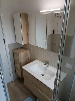 a bathroom with a sink and a mirror at Appartamento Casa Florio Mondello in Palermo