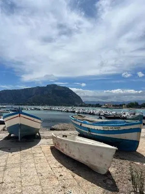 three boats sitting on the shore of a beach at Appartamento Casa Florio Mondello in Palermo