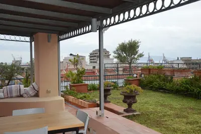 a patio with a table and a view of the city at Appartamento con vista in Palermo