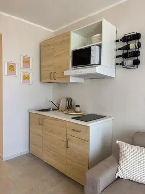 a small kitchen with a microwave and a counter at Casa Tulum - Sea View & Breakfast in Palermo