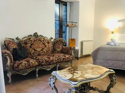 a living room with a couch and a coffee table at Apartment Via Vittorio Emanuele & Vucciria in Palermo