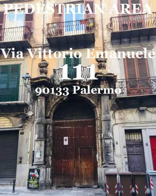 a building with a large wooden door on it at Apartment Via Vittorio Emanuele & Vucciria in Palermo