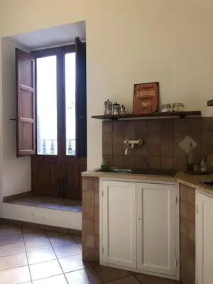 a kitchen with a sink and a window and a door at Apartment Via Vittorio Emanuele & Vucciria in Palermo