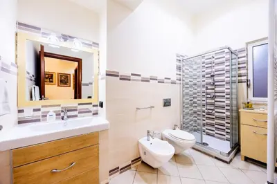 a bathroom with a sink and a toilet and a shower at MG Apartment in Palermo