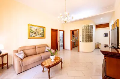 a living room with a couch and a table at MG Apartment in Palermo