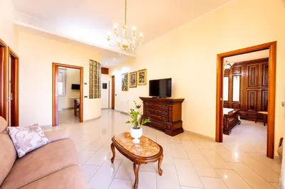 a living room with a couch and a table at MG Apartment in Palermo