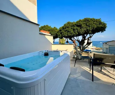 a hot tub on the side of a building at Sunrise in Santa Flavia