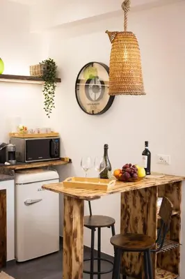 a kitchen with a wooden table and some wine glasses at Sunrise in Santa Flavia