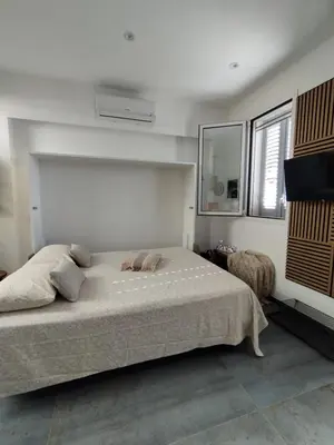a bedroom with a large bed and a window at Sunrise in Santa Flavia
