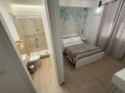 a small bedroom with a bed and a shower at Bart165 Luxury Rooms in Palermo
