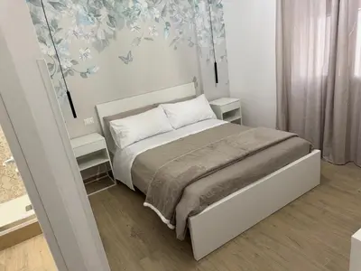 a bedroom with a bed with two night stands at Bart165 Luxury Rooms in Palermo