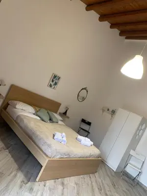 a bedroom with a bed with two towels on it at Risvegliarsi a Danisinni in Palermo