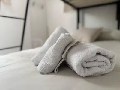 a towel animal is sitting on a bed at Arco Apartment in Bagheria