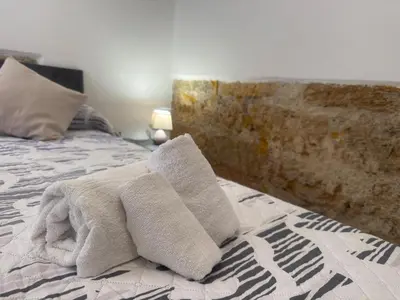 a bedroom with a bed with towels on it at Arco Apartment in Bagheria