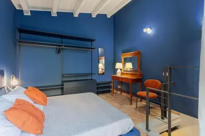 a blue bedroom with a bed and a desk at Prospettiva Ballarò - Sotto la cupola in Palermo