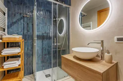 a bathroom with a sink and a glass shower at Prospettiva Ballarò - Sotto la cupola in Palermo