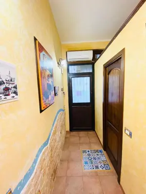 a hallway with a door and a tile floor at Home sweet home in Santa Flavia