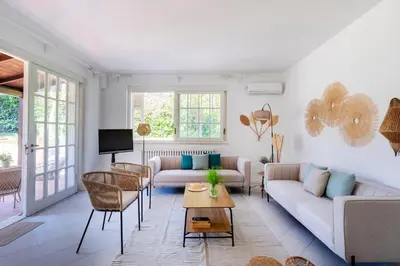 a living room with a couch and a table at Donna Amalia villa in Mondello in Palermo
