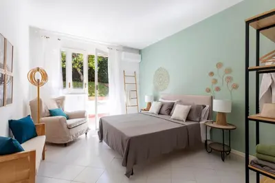 a bedroom with a bed and a couch and a chair at Donna Amalia villa in Mondello in Palermo