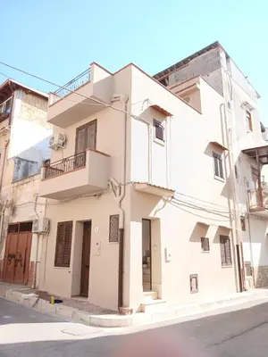 a white building on the side of a street at Tampasiando Limoni in Cinisi