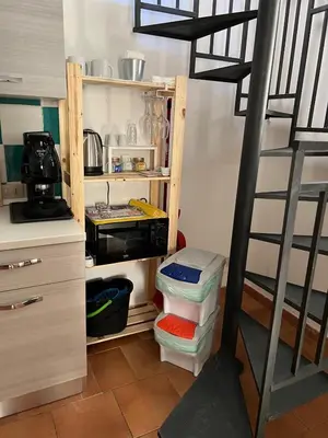 a kitchen with a ladder and a shelf with food at Tampasiando Limoni in Cinisi