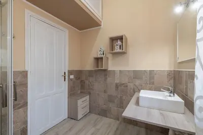 a bathroom with a sink and a mirror at GuestHost - Ballarò Flat dei Sovrani x6 in Palermo