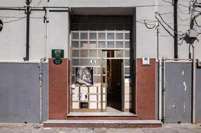 a door to a building with a sign on it at GuestHost - Ballarò Flat dei Sovrani x6 in Palermo